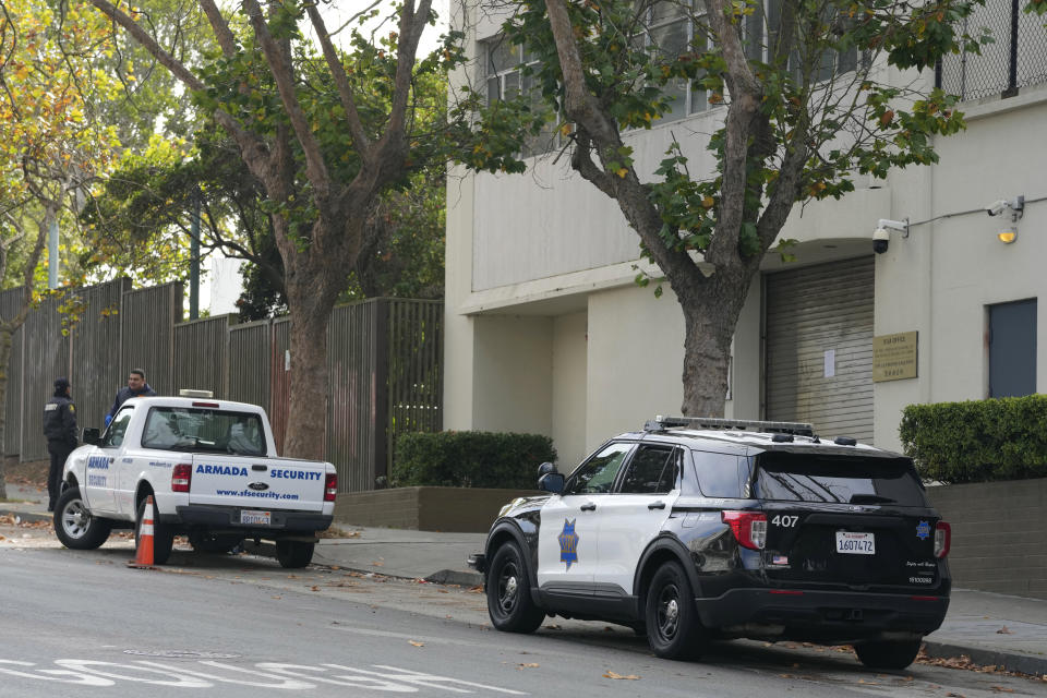 Police and security are stationed outside the Chinese consulate in San Francisco, Tuesday, Oct. 10, 2023. A car rammed into the consulate in San Francisco on Monday, coming to a stop in the lobby and creating a chaotic scene that ended with police shooting the driver, who later died at the hospital, officials said. (AP Photo/Eric Risberg)