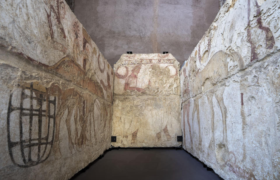 Painted slabs from a 3rd century BC male burial and depicting a funeral procession (right and left walls) and a scene of the deceased being welcomed into the underworld (back wall) are on display at the exhibition 'Between us and the ancients. The instant and eternity' in Rome's Diocletian Baths, Wednesday, May 3, 2023. The exhibition will open to the public from May 4 through July 30, 2023. (AP Photo/Domenico Stinellis)