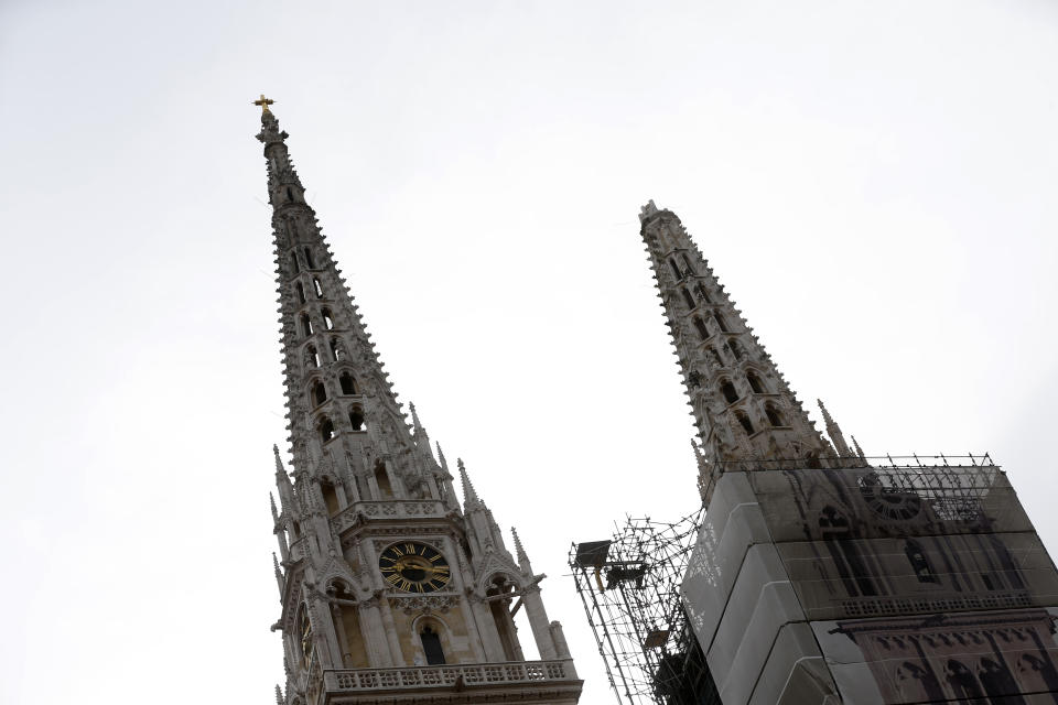 One of the damaged spires, right, of Zagreb's iconic cathedral is seen after an earthquake in Zagreb, Croatia, Sunday, March 22, 2020. The cathedral was rebuilt after it toppled in the 1880 earthquake. A strong earthquake shook Croatia and its capital on Sunday, causing widespread damage and panic. (AP Photo/Darko Bandic)