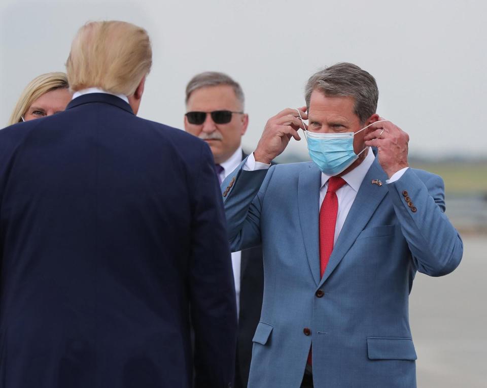 Georgia Gov. Brian Kemp, right, greets President Donald Trump as he visits Georgia to talk about an infrastructure overhaul at the UPS Hapeville hub at Hartsfield-Jackson International Airport in Atlanta on July 15.