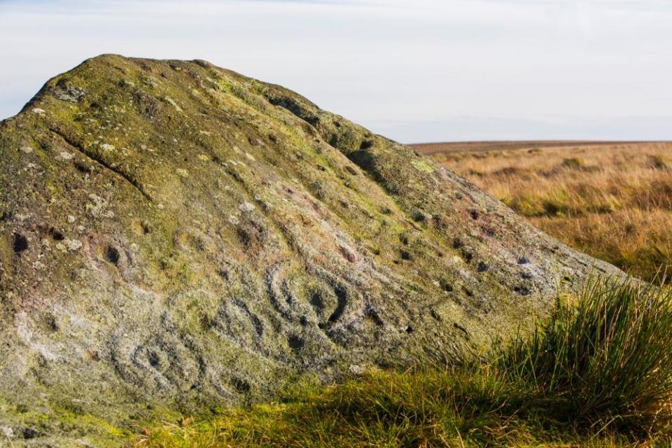 Cup and ring marks on the ancient Badger Stone on Ilkley Moor, Yorkshire, UK.