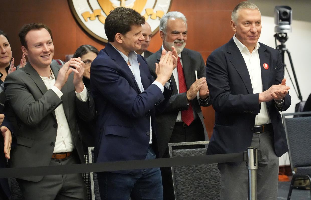 Ratmir Timashev, right, an Ohio State alumnus who built successful tech businesses in Columbus, is congratulated Thursday for making a $110 million donation to Ohio State University to establish a center and interdisciplinary program focused on software innovation. The donation, gifted from the Timashev Family Foundation, is the largest single gift in Ohio State history.