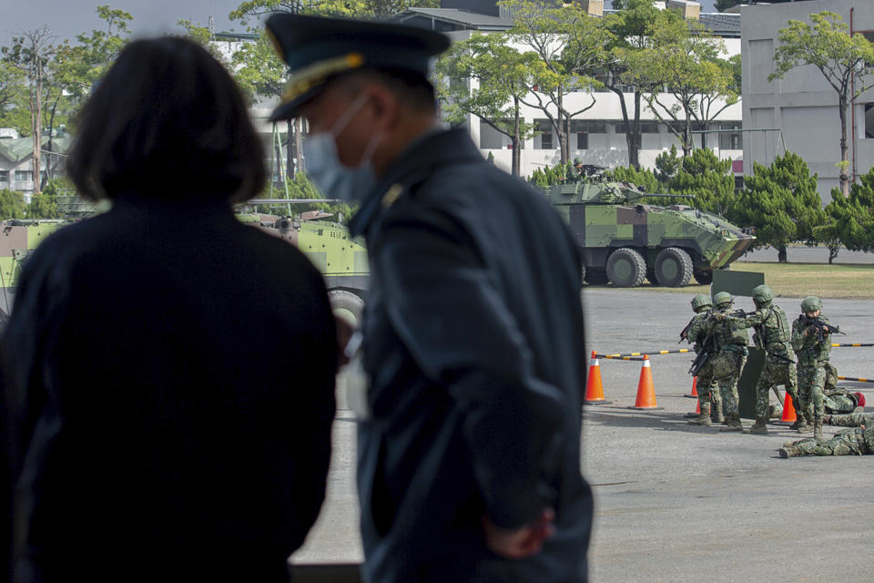 In this photo released by the Taiwan Presidential Office, Taiwan's President Tsai Ing-wen, left, talks to a military officer as she inspects a military drills at a military base in Chiayi, southwestern Taiwan, Friday, Jan. 6, 2023. President Tsai visited a military base Friday to observe drills while rival China protested the passage of a U.S. Navy destroyer through the Taiwan Strait, as tensions between the sides showed no sign of abating in the new year. (Taiwan Presidential Office via AP)