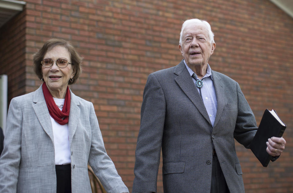 Former President Jimmy Carter walks with his wife Rosalynn after teaching Sunday School class at the Maranatha Baptist Church on Dec. 13, 2015, in Plains, Ga. (AP Photo/Branden Camp)