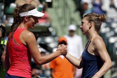 Mar 29, 2017; Miami, FL, USA; Johanna Konta of Great Britain (left) shakes hands with Simona Halep of Romania (right) after their match on day nine of the 2017 Miami Open at Crandon Park Tennis Center. Konta won 3-6, 7-6(7), 6-2. Geoff Burke-USA TODAY Sports