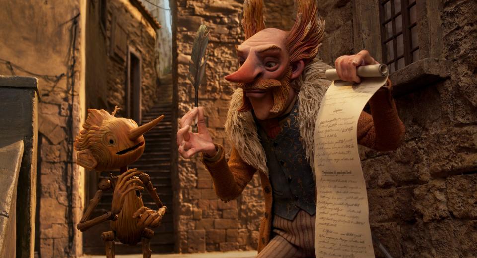 Pinocchio (voiced by Gregory Mann, left) signs on as a circus performer with the villainous Count Volpe (Christoph Waltz) in the stop-motion animated film.