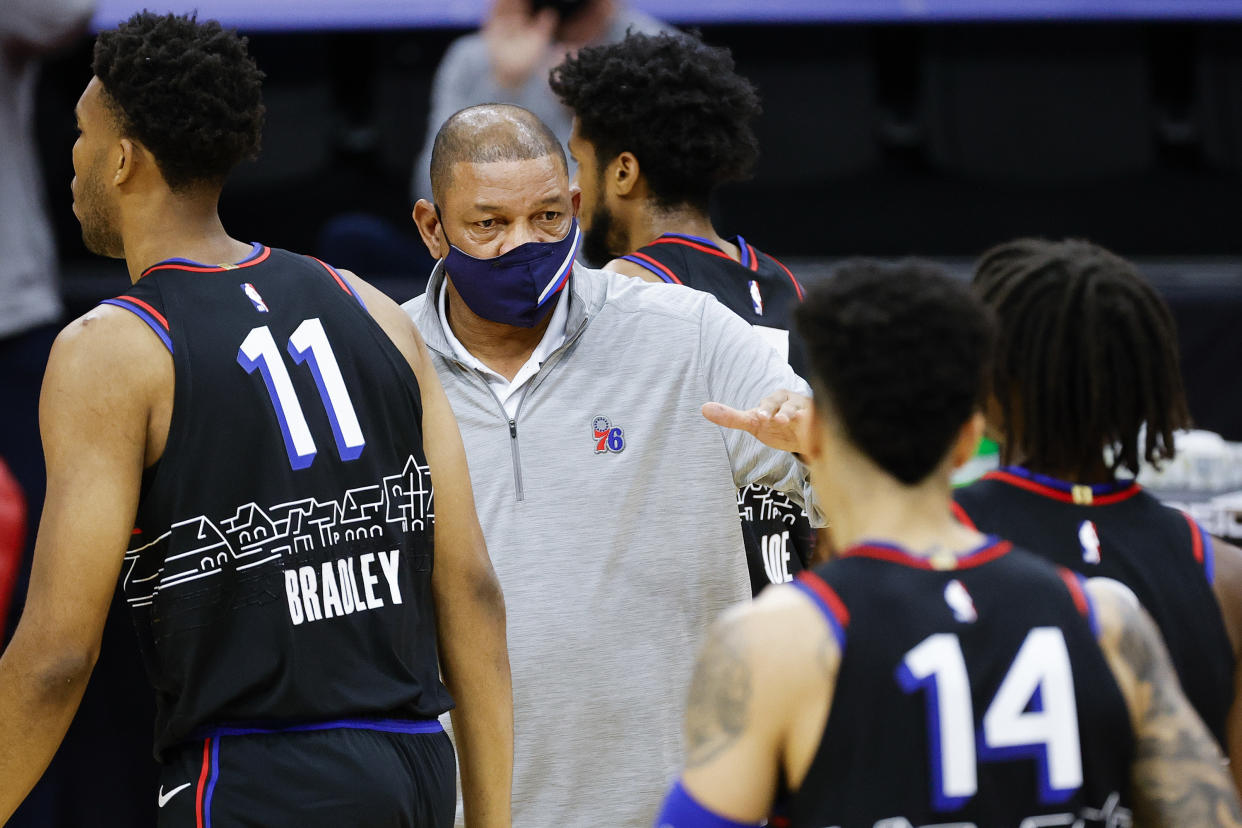 Head coach Doc Rivers of the Philadelphia 76ers high fives players during the first quarter against the Denver Nuggets