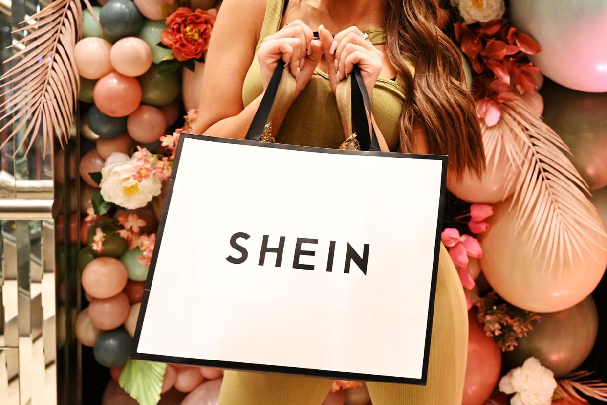 A woman holds a Shein shopping bag  (Shirlaine Forrest / Getty Images for SHEIN file)