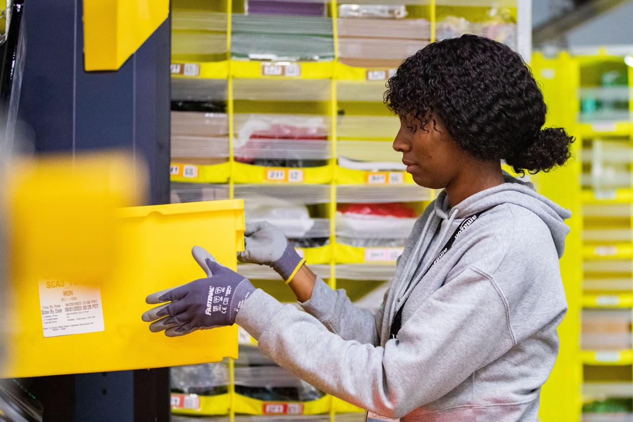 An Amazon employee sorts products to be sent to packaging in the Amazon facility in Tallahassee on Wednesday, Sept. 13, 2023.