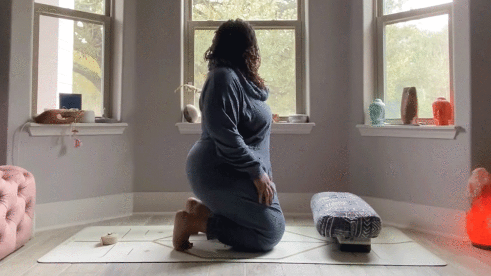 Woman doing toe squat in her bedroom
