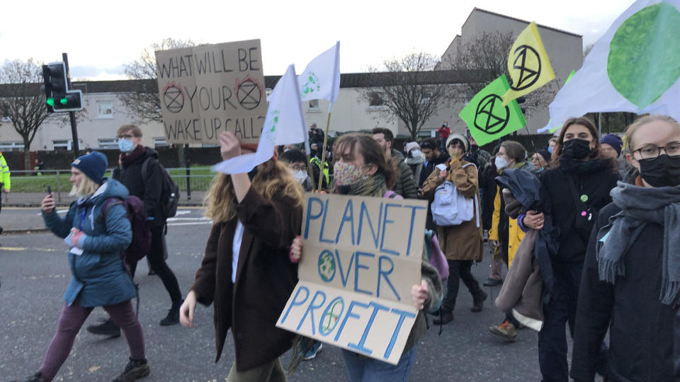 Activists from Extinction Rebellion and Fridays for Future hold up signs as they march for climate justice in Glasgow, Scotland, during the U.N. Climate Change Conference. 