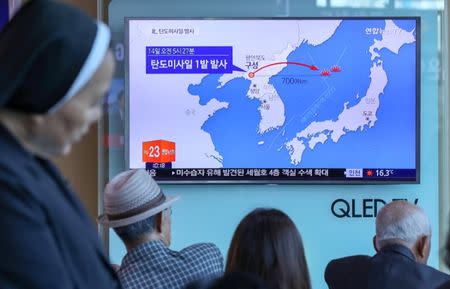 People watch a news report on North Korea firing a ballistic missile, at a railway station in Seoul, South Korea, May 14, 2017. Kim Do-hoon/Yonhap via REUTERS