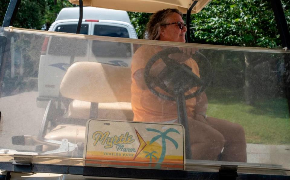 Becky Robertson sits on a golf cart used in the filming of ‘Welcome to Myrtle Manor’, a reality TV show set in Myrtle Beach that filmed for three seasons beginning in 2013 at Patrick’s Mobile Home park of Highway 15 in Myrtle Beach, S.C. July 6, 2023. JASON LEE/jlee@thesunnews.com