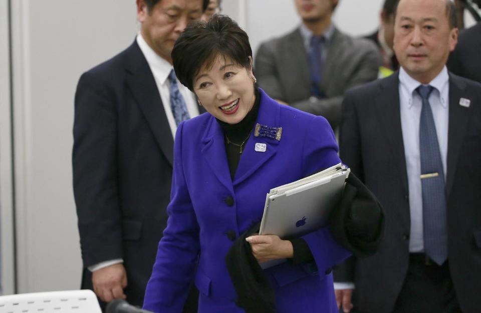 Tokyo Gov. Yuriko Koike arrives at the Four-Party Working Group meeting in Tokyo, Wednesday, Dec. 21, 2016. Japanese Olympic organizers presented their first official cost estimate for the 2020 Tokyo Games at a level slightly below their promised 2 trillion ($17 billion) cap. (AP Photo/Shizuo Kambayashi)