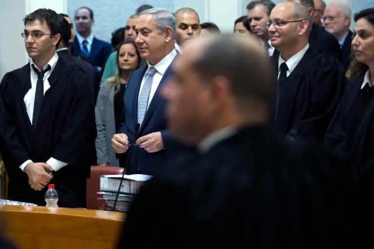 Israeli Prime Minister Benjamin Netanyahu (2 L) stands with his lawyers in the Supreme Court in Jerusalem as they wait for the arrival of the judges, on February 14, 2016