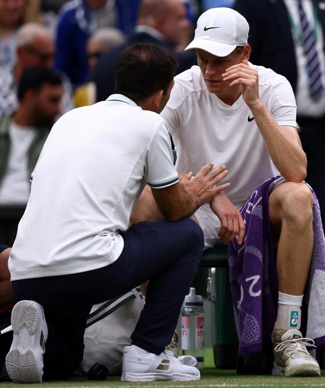 Health scare: Jannik Sinner talks to staff during a medical time-out (HENRY NICHOLLS)