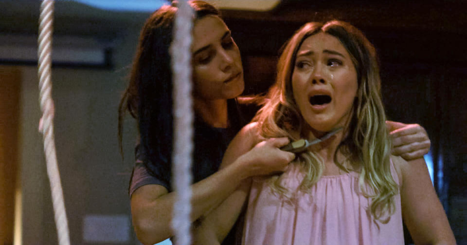 Hilary Duff's character being held with a knife at her throat