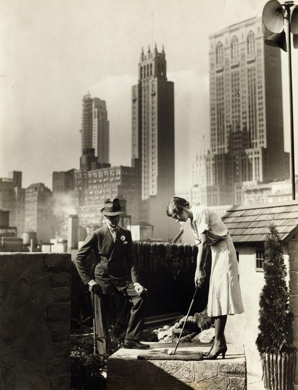 <p>Fred Astaire joins a female companion for a round of mini golf atop a New York City skyscraper in 1930. </p>