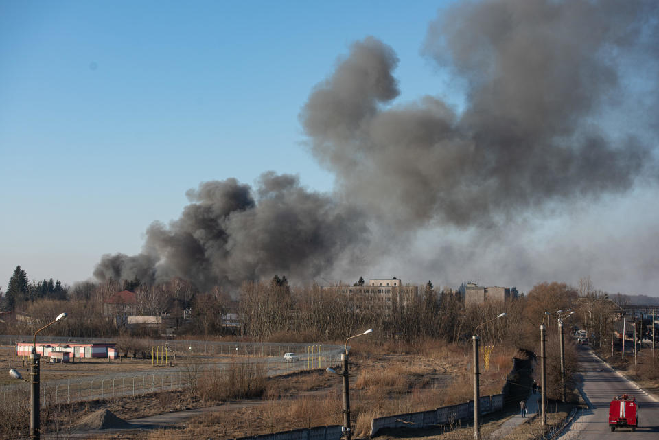 Smoke is seen above buildings close to the airport in Lviv, western Ukraine, after an apparent Russian airstrike, March 18, 2022. / Credit: Getty