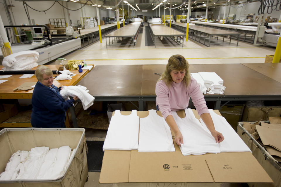 FILE - In this Monday, Oct. 15, 2012 file photo, Judy Dross, left, and Gloria Bambrick count and stack components of T-shirts at FesslerUSA apparel manufacture in Orwigsburg, Pa. Superstorm Sandy depressed U.S. industrial output in October, while production of machinery and equipment declined sharply, reflecting a more cautious outlook among businesses, according to Federal Reserve reports, Friday, Nov. 16, 2012. (AP Photo/Matt Rourke, File)