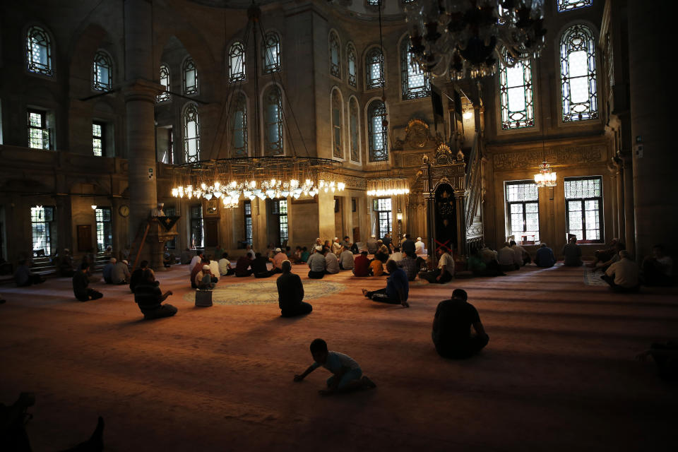 People sit in a mosque in Istanbul before of prayers on Wednesday, Aug. 15, 2018. Turkey is deeply divided between Erdogan’s pious Muslim base and secular Turks who once held sway over the country. (AP Photo/Lefteris Pitarakis)