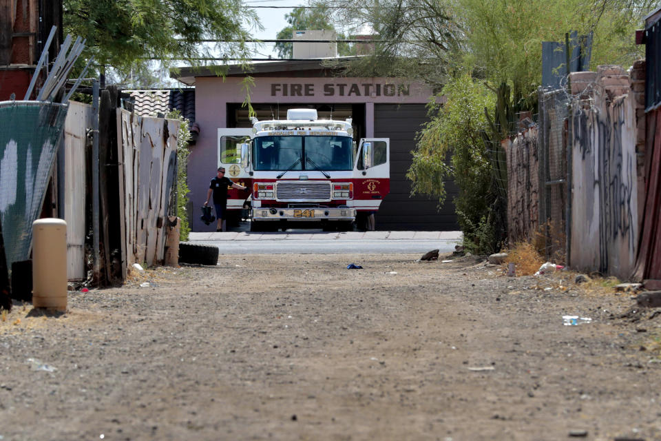 In this Saturday, June 13, 2020, photo, Guadalupe firefighters prepare their engine prior to a call in Guadalupe, Ariz. As the coronavirus spreads deeper across America, it's ravaging through the homes and communities of Latinos from the suburbs of the nation's capital to the farm fields of Florida to the sprawling suburbs of Phoenix and countless communities in between. (AP Photo/Matt York)