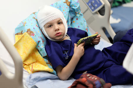 Four-year old Ely Bowman receives his drug treatment for Batten disease at the Orange County Children's Hospital in Orange, California, U.S. August 25, 2017. REUTERS/Mike Blake/Files