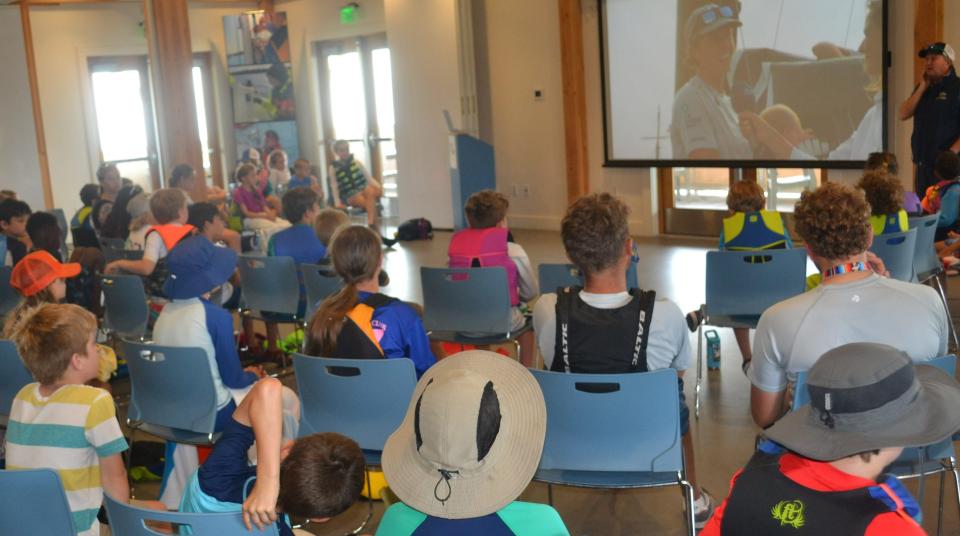 Sail Newport's youth sailors gather between their morning and afternoon sailing sessions to watch Newport-based 11th Hour Racing Team, winner of the 2023 Ocean Race, arrive in Genoa, Italy on June 29,2023.