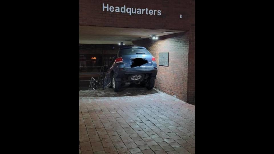 Officials posted photos showing the woman’s SUV stuck on the stairs at the police department.