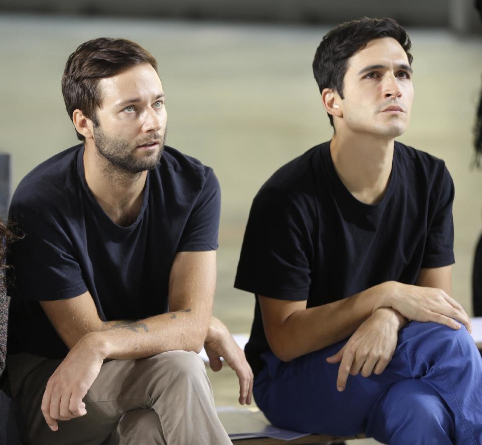 Proenza Schouler designers Jack McCollough, left, and Lazaro Hernandez watch a run-through before their Spring 2014 collection is modeled during Fashion Week in New York, Wednesday, Sept. 11, 2013. (AP Photo/Seth Wenig)