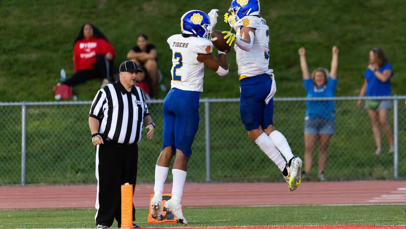 Orem players celebrate a touchdown during their high school football season opener against East at East High School in Salt Lake City on Friday, Aug. 11, 2023.