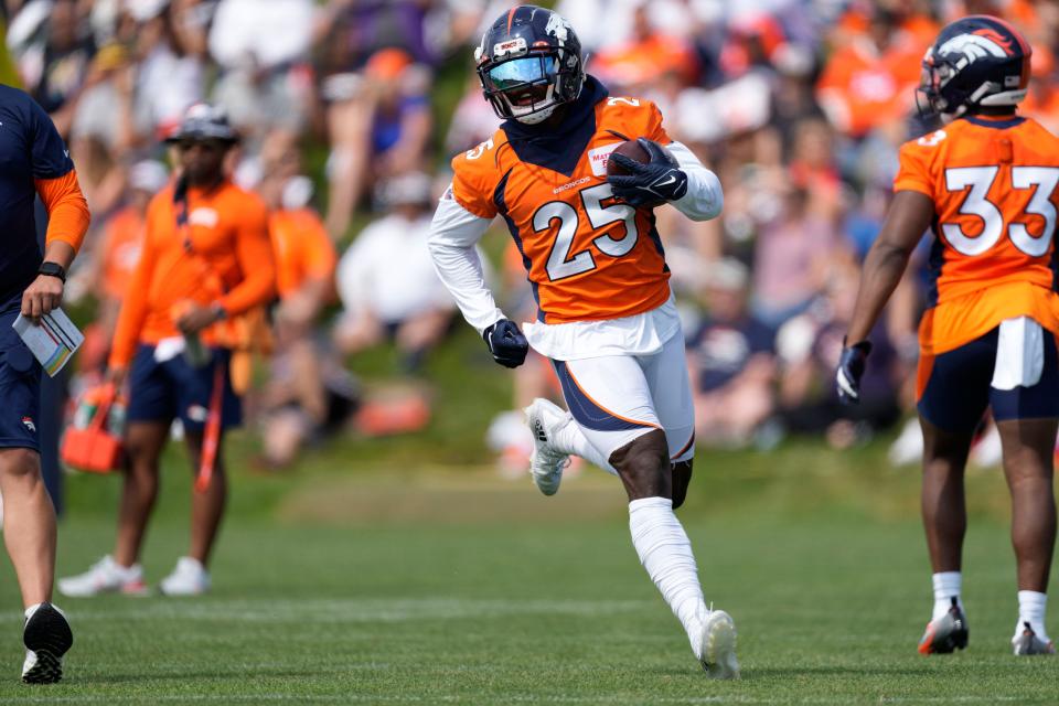 Denver Broncos running back Melvin Gordon III (25) takes part in drills during the NFL football team's training camp Friday, July 29, 2022,in Centennial, Colo.