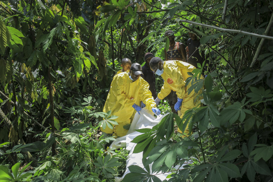 Forensics workers search for human remains at a mass grave in the village of Ndoma, near Beni in North Kivu, Congo Saturday, May 6, 2023. The remains of at least 20 people were found buried in a mass grave in an area used to cultivate cacao in Ndoma village in Congo's North Kivu province this weekend, according to local authorities and a military spokesperson. (AP Photo)