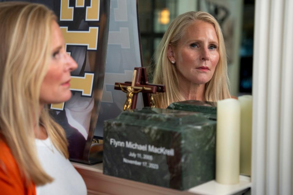 Anne Vanker, of Grosse Pointe, Michigan, stands by the ashes of her late son Flynn MacKrell at her home on Friday, July 26, 2024. Vanker is demanding justice for the death of her 18-year-old son, who was killed in a car crash when his friend barreled into a lamp post at 105 mph. She wants the mother of the driver charged with involuntary manslaughter.