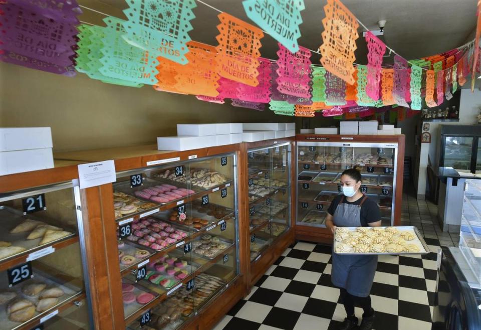 Rosi Garcia carries out a tray of freshly baked pastries at her family’s Panderia Cafe Oaxaca on Feb. 15.