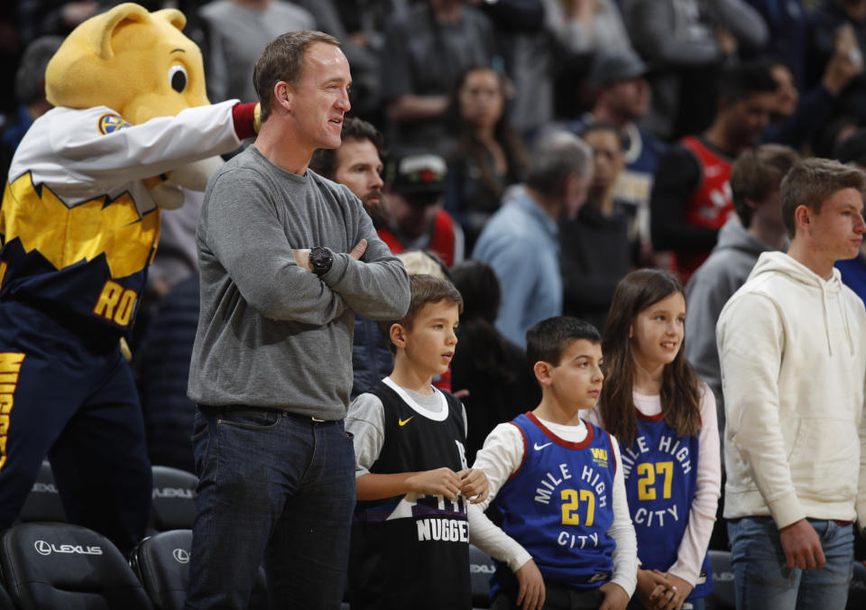 Retired NFL quarterback Peyton Manning looks on as the Denver Nuggets host the Toronto Raptors in the first half of an NBA basketball game Sunday, March 1, 2020. (AP Photo/David Zalubowski)