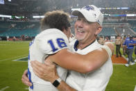 Middle Tennessee head coach Rick Stockstill, right, hugs quarterback Chase Cunningham (16) after they beat Miami 45-31 in an NCAA college football game, Saturday, Sept. 24, 2022, in Miami Gardens, Fla. (AP Photo/Wilfredo Lee)