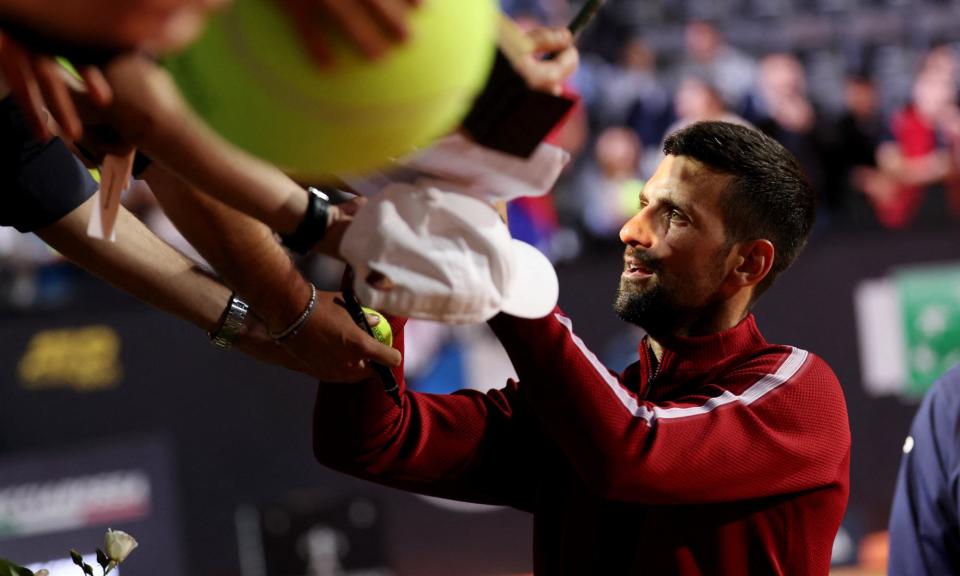 <span>Novak Djokovic signs autographs for fans shortly before being struck by a metal bottle.</span><span>Photograph: Claudia Greco/Reuters</span>