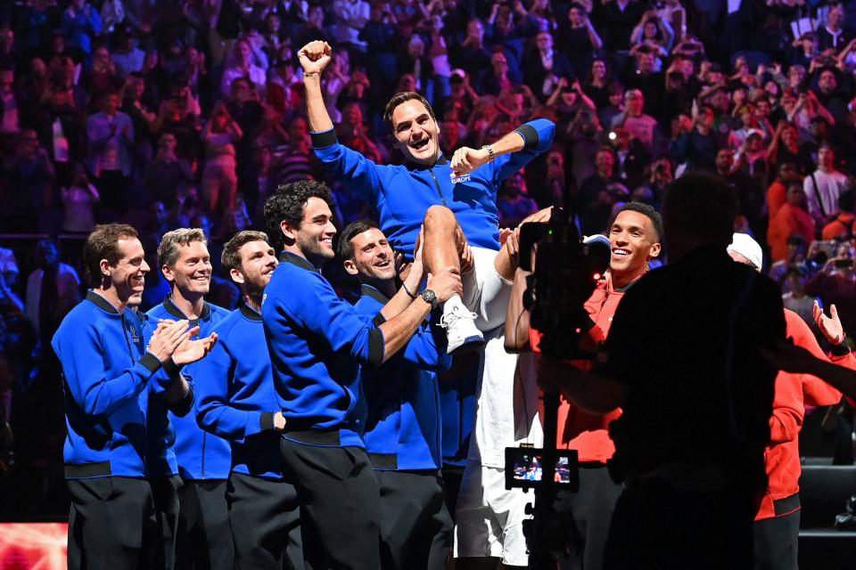 Switzerland's Roger Federer is given the bumps by teammates after playing his final match, a doubles with Spain's Rafael Nadal of Team Europe against USA's Jack Sock and USA's Frances Tiafoe of Team World in the 2022 Laver Cup at the O2 Arena in London, early on September 24, 2022. - Roger Federer brings the curtain down on his spectacular career in a 