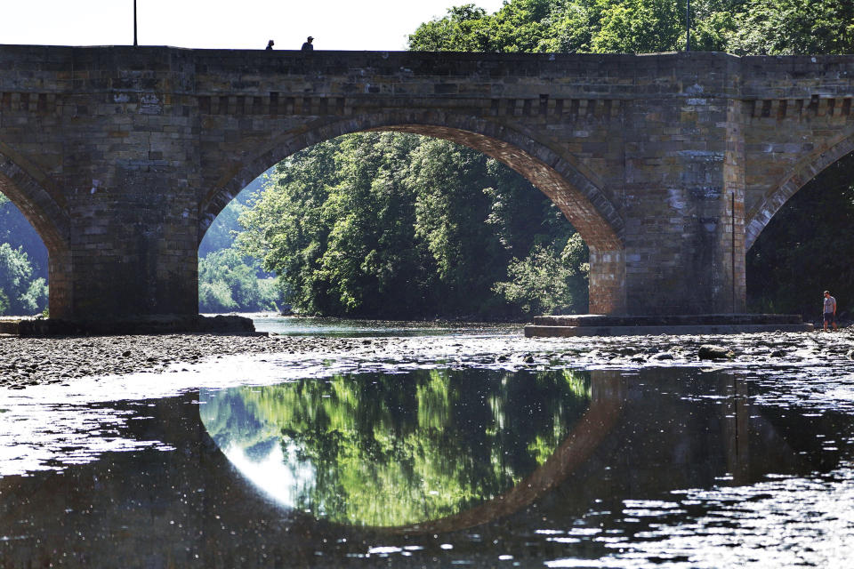 Low water levels on the river Tyne at Corbridge, England, Monday June 1, 2020. Families who are locked down because of the coronavirus have been able to visit local beauty spots as warm weather has swept the region. (Owen Humphreys/PA via AP)