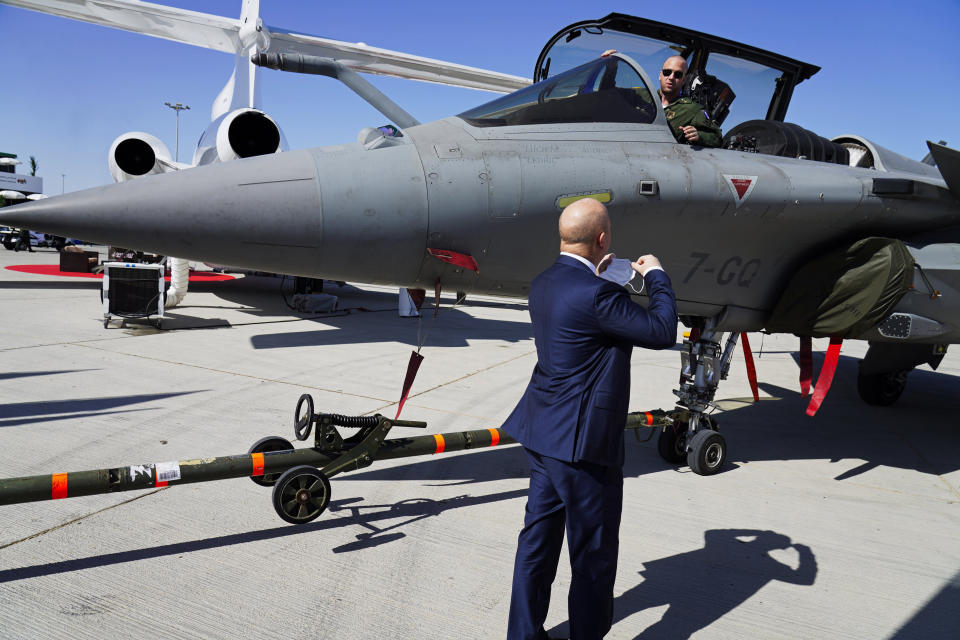 A French pilot sits in his Dassault Rafale fighter jet as it is pulled into position at the Dubai Air Show in Dubai, United Arab Emirates, Sunday, Nov. 14, 2021. The biennial Dubai Air Show opened Sunday as commercial aviation tries to shake off the coronavirus pandemic. (AP Photo/Jon Gambrell)