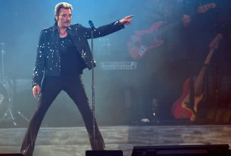 FILE PHOTO: French rock singer Johnny Hallyday performs at the Stade de France in Saint Denis, Paris suburb, France, May 29, 2009. REUTERS/Philippe Wojazer/File Photo