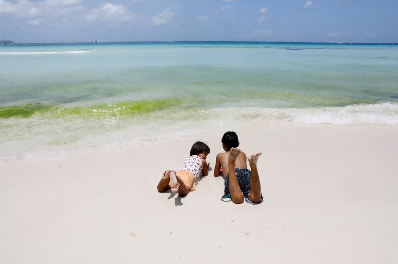 FILE PHOTO: Children frolic along the beach of Boracay