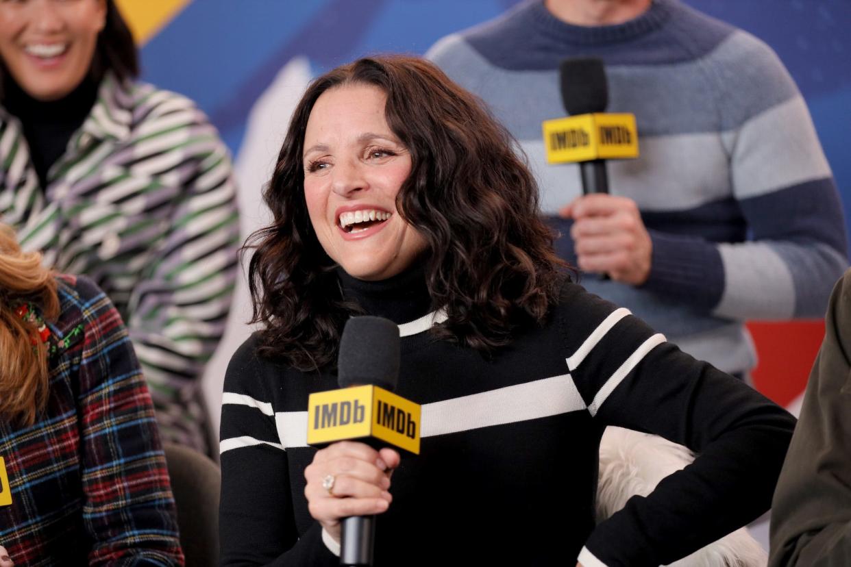 Actress Julia Louis-Dreyfus, pictured mid-laugh while holding a microphone, fields questions about her new movie at the IMDb Studio at Acura Festival Village on location at the 2020 Sundance Film Festival – Day 2 on January 25, 2020 in Park City, Utah.