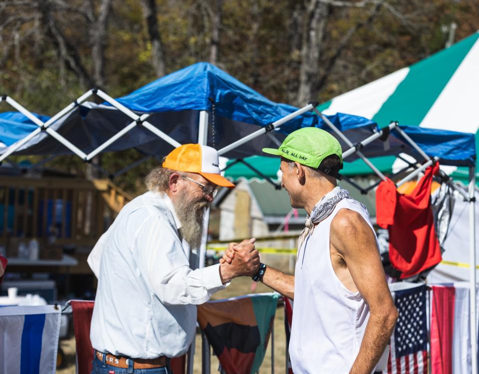 Harvey Lewis (right) greets Gary "Lazarus Lake" Cantrell (left), the mastermind behind the Big Dog Backyard Ultramarathon.