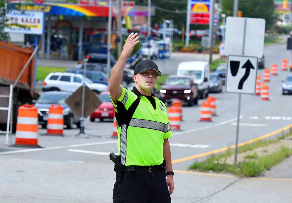 In this Aug. 7, 2018, file photo, a Worcester police officer directs traffic during a construction detail.