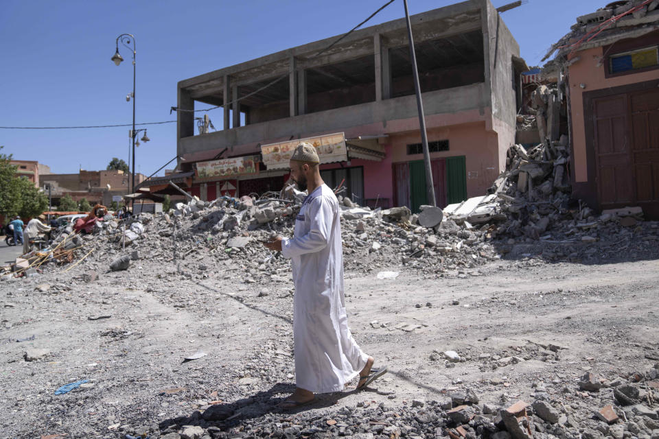 A man walks near the rubble of buildings after the earthquake, in the town of Amizmiz, near Marrakech, Morocco, Sunday, Sept. 10, 2023. An aftershock rattled Moroccans on Sunday as they prayed for victims of the nation’s strongest earthquake in more than a century and toiled to rescue survivors while soldiers and workers brought water and supplies to desperate mountain villages in ruins. (AP Photo/Mosa'ab Elshamy)