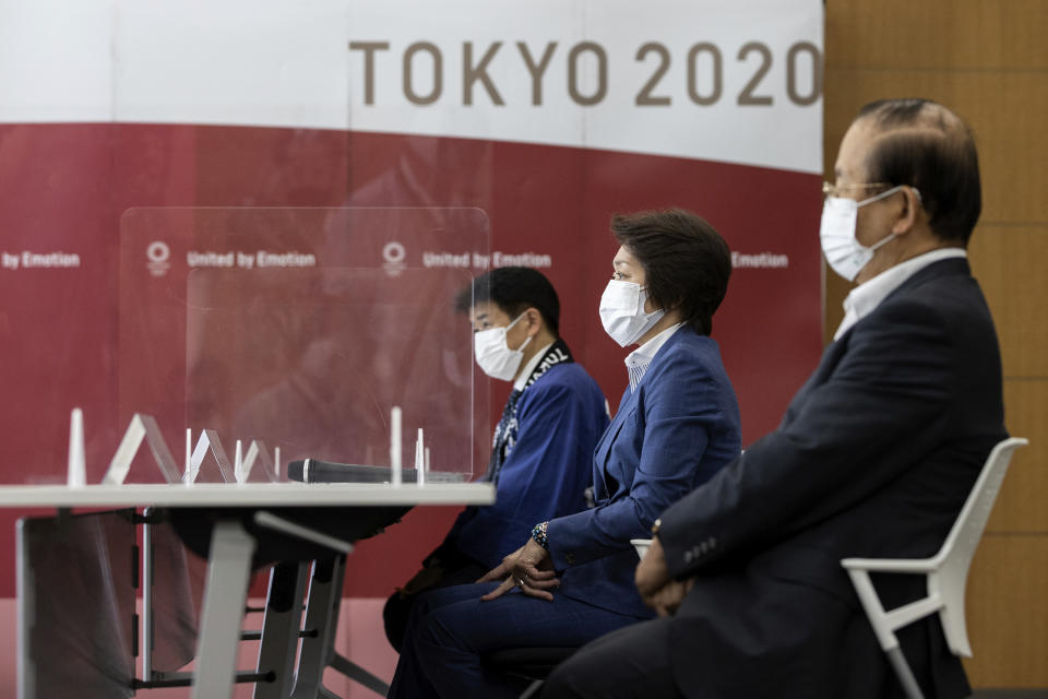 Tokyo 2020 Games Delivery Officer Hidemasa Nakamura, left, Tokyo 2020 President Seiko Hashimoto, center, and Tokyo 2020 CEO Toshiro Muto attend a meeting with IOC President Thomas Bach at the Tokyo 2020 Headquarters Tuesday, July 13, 2021 in Tokyo, Japan. Bach appeared in public on Tuesday for the first time since arriving in Tokyo last week with the pandemic-postponed Olympics opening in just 10 days. (Takashi Aoyama/Pool Photo via AP)