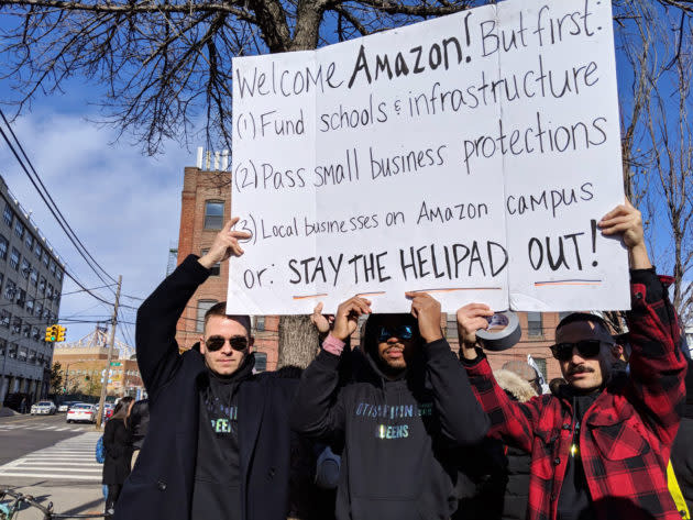 Shawn Dixon, left, joins other protesters in Queens, N.Y., who are worried about their neighborhood and businesses when Amazon comes to town. (GeekWire Photo / Monica Nickelsburg) <a href="https://www.geekwire.com/2018/new-yorkers-protest-amazon-hq2-investing-housing-not-helicopters/" rel="nofollow noopener" target="_blank" data-ylk="slk:Read the story.;elm:context_link;itc:0;sec:content-canvas" class="link "><strong>Read the story.</strong></a>