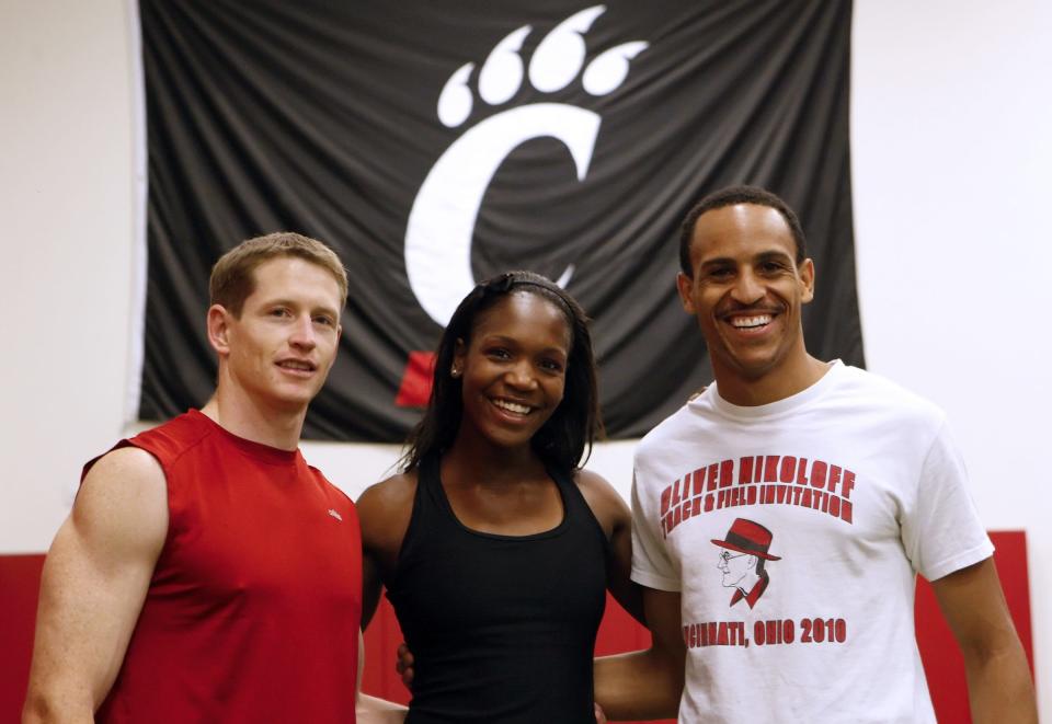 Chris Wineberg, left, coached and trained his wife Mary, center, during her USA Track and Field days. Both are now members of the UC James P. Kelly Athletic Hall of Fame.